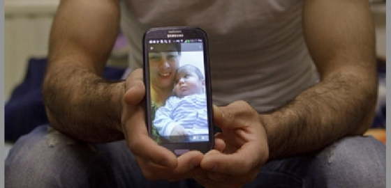 Rustam Nazarov displays a photo of his late son Umarali on the screen of his telephone. Photo: Elena Lukyanova