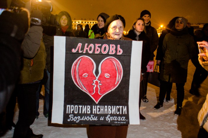 Local artist Yelena Osipova, a fixture at opposition protests in Petersburg, holds a homemade placard that reads, "