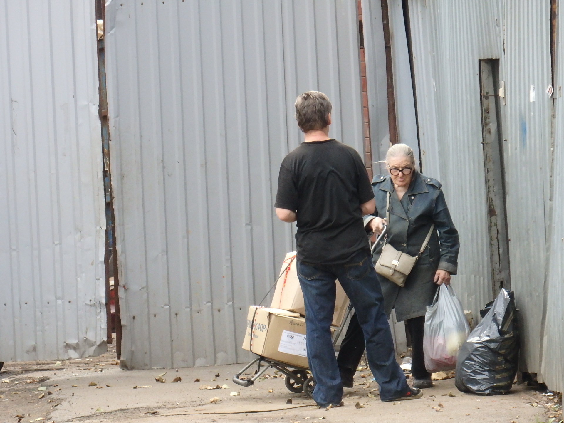 An elderly woman turning in scrap paper and other junk to supplement her pension.