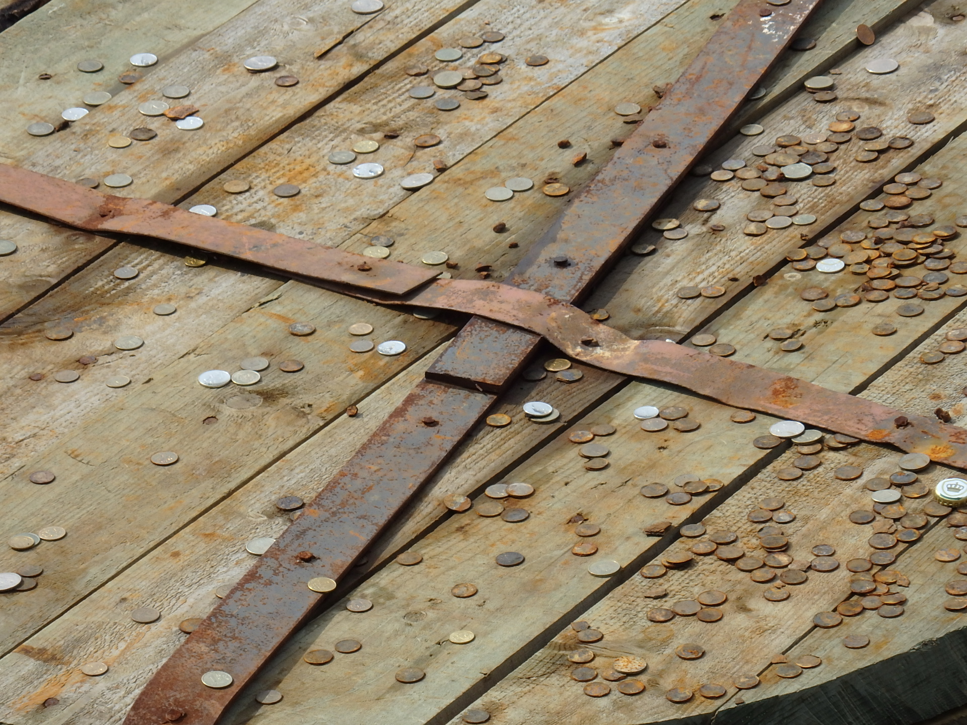 Coins tossed for good luck onto a stanchion in the Fontanka River
